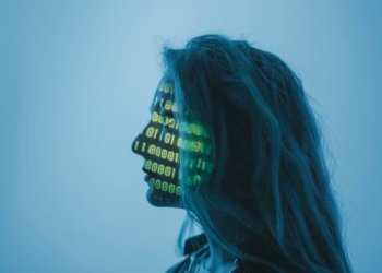 Silhouette of a woman with binary code projected on her face in a digital concept setting.